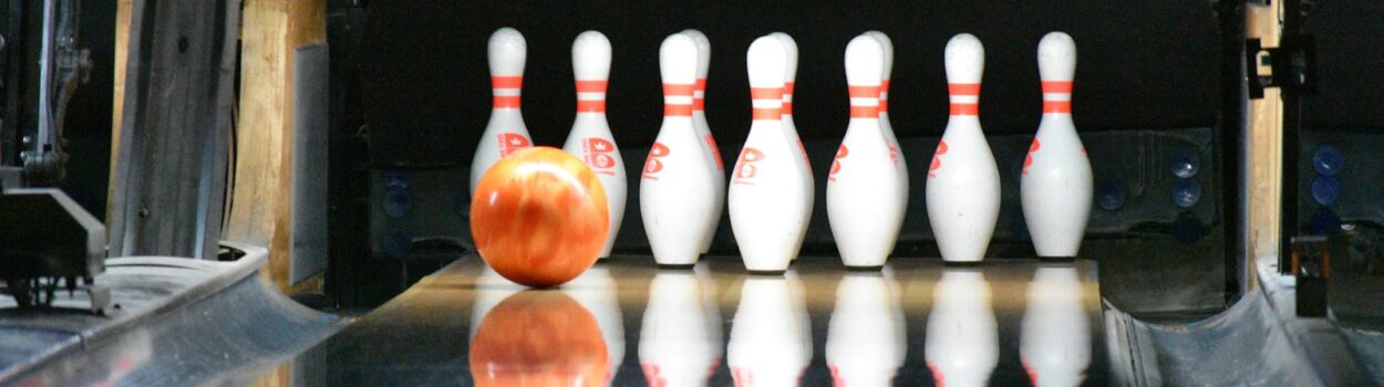 une boule de bowling va frapper les quilles